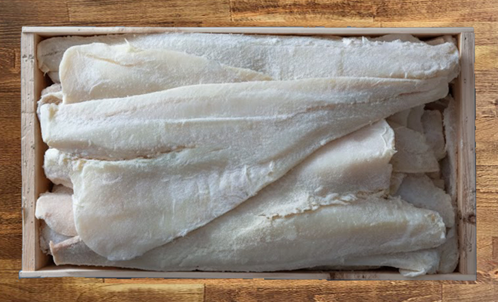Salt Cod Whole fillets in a wooden crate on a wooden surface