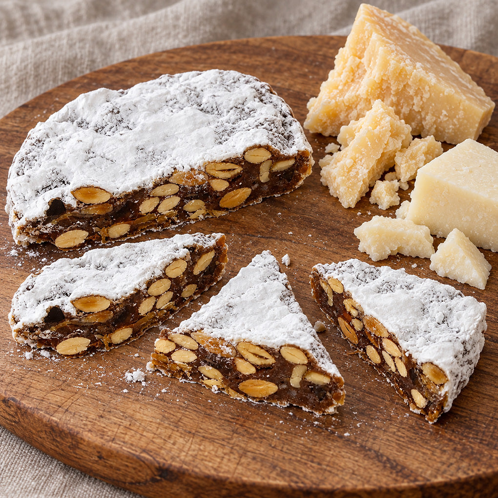 La Florentine Panforte wedges with Parmigiano-Reggiano and Pecorino Romano on a wooden board