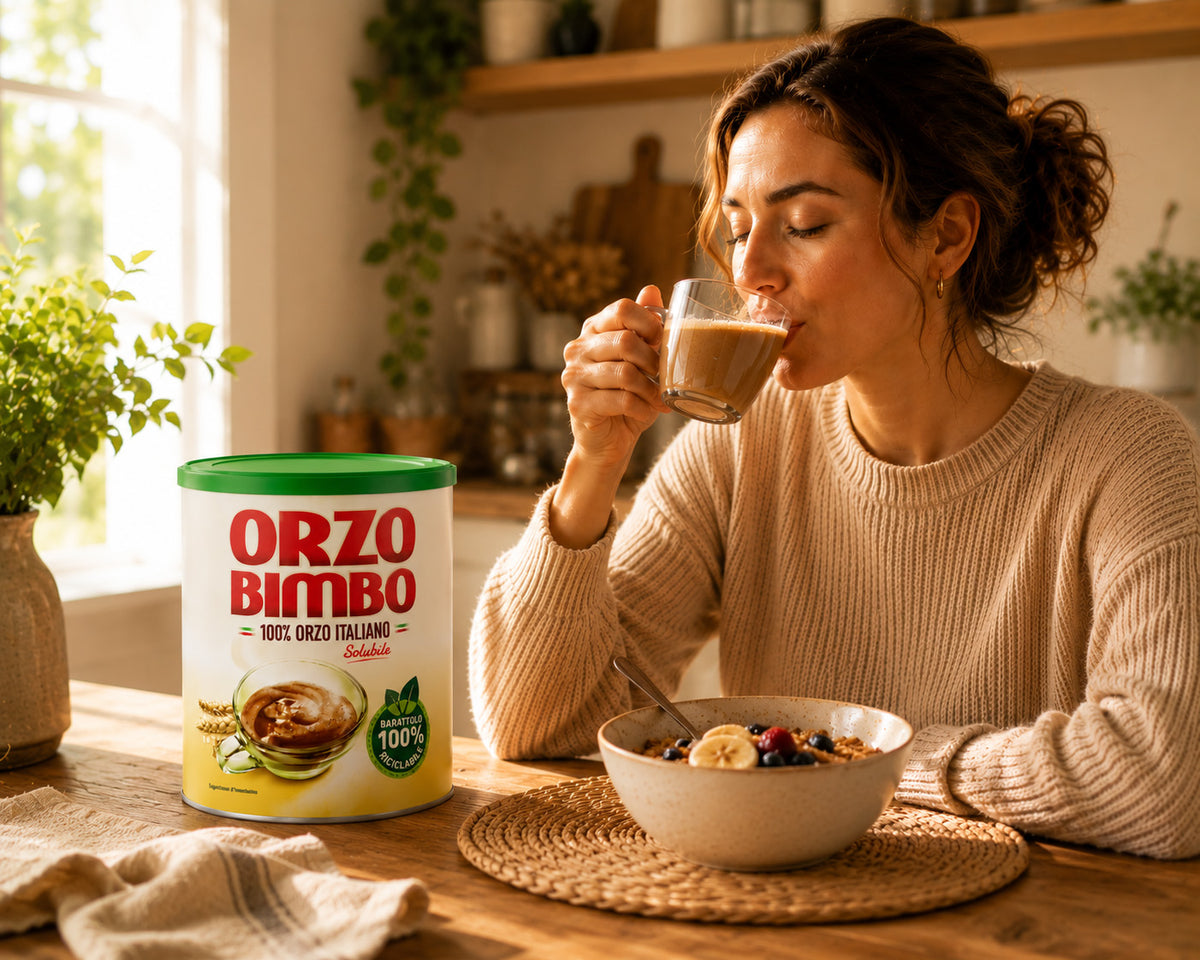 Woman drinking from a glass of orzo bimbo with the can on the table 