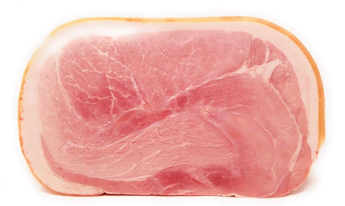 A fresh piece of Prosciutto Cotto, Italian cooked ham, displayed on a white background.