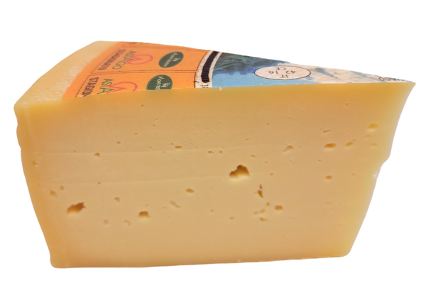 Wedge of aged Asiago Stagionato DOP Italian cheese